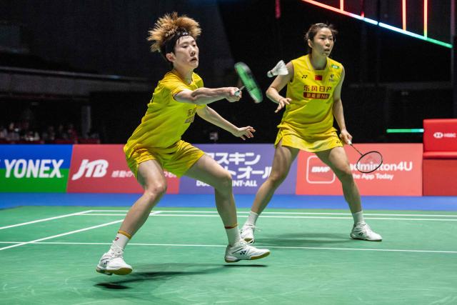 China’s Jia Yifan and Zhang Shuxian play a point against South Korea’s Kim Hye-jeong and Kong Hee-yong during the women's doubles final of the Japan Open badminton tournament at Tokyo Gymnasium in Tokyo on July 19, 2026. (Photo by Yuichi YAMAZAKI / AFP)