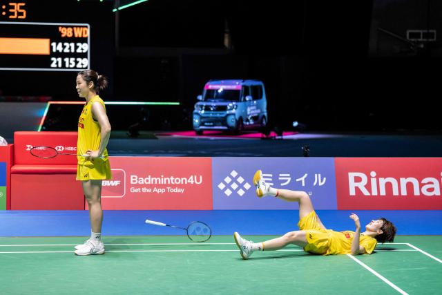 China’s Jia Yifan and Zhang Shuxian react after losing against South Korea’s Kim Hye-jeong and Kong Hee-yong during the women's doubles final of the Japan Open badminton tournament at Tokyo Gymnasium in Tokyo on July 19, 2026. (Photo by Yuichi YAMAZAKI / AFP)