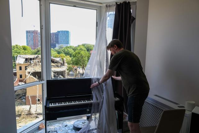 A local resident cleans his damaged apartment following missile strikes in Kyiv on July 19, 2026, amid the Russian invasion of Ukraine. Russian missiles rocked Ukraine's capital overnight, damaging residential buildings and wounding at least two people a day after Kyiv launched a wave of drone strikes deep into Russian territory. (Photo by Serhii Okunev / AFP)