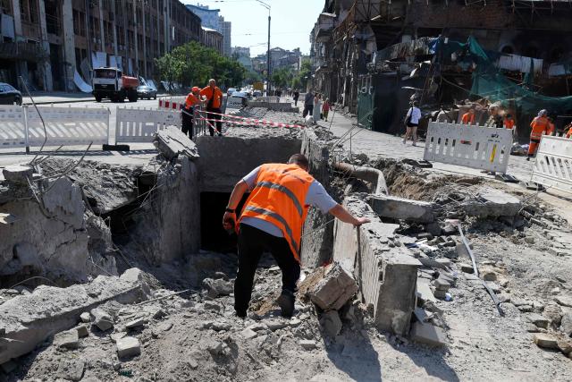 Communal workers clear debris from an underground pedestrian crossing damaged by missile strikes in Kyiv on July 19, 2026, amid the Russian invasion of Ukraine. Russian missiles rocked Ukraine's capital overnight, damaging residential buildings and wounding at least two people a day after Kyiv launched a wave of drone strikes deep into Russian territory. (Photo by Serhii Okunev / AFP)