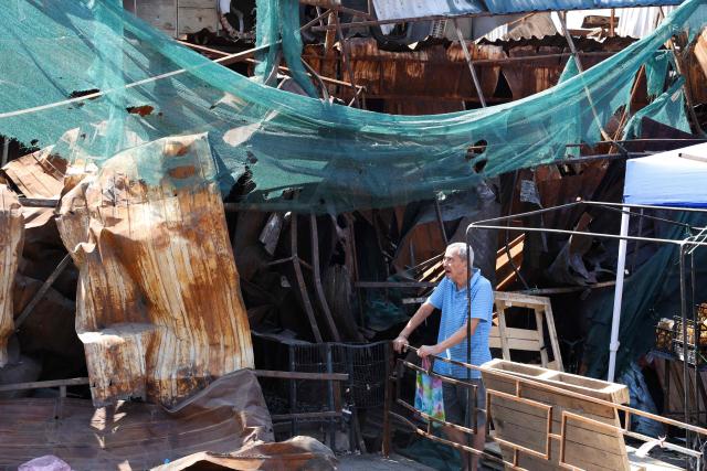 A man looks at a shopping mall damaged by missile strikes in Kyiv on July 19, 2026, amid the Russian invasion of Ukraine. Russian missiles rocked Ukraine's capital overnight, damaging residential buildings and wounding at least two people a day after Kyiv launched a wave of drone strikes deep into Russian territory. (Photo by Serhii Okunev / AFP)