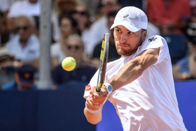 Belgium's Raphael Collignon returns the ball to Greece's Stefanos Tsitsipas during their men's singles final match at the Swiss Open tennis tournament in Gstaad, on July 19, 2026. (Photo by Fabrice COFFRINI / AFP)