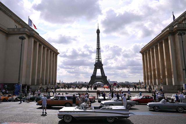Participants park their car at the Trocadero, with the Eiffel Tower seen in the background, during the 19th Summer parade of vintage vehicles in Paris on July 19, 2026. (Photo by Lou BENOIST / AFP)