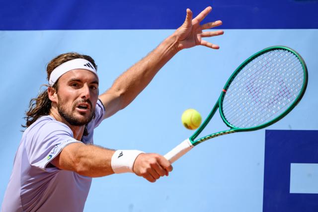 Greece's Stefanos Tsitsipas returns the ball to Belgium's Raphael Collignon during their men's singles final match at the Swiss Open tennis tournament in Gstaad, on July 19, 2026. (Photo by Fabrice COFFRINI / AFP)