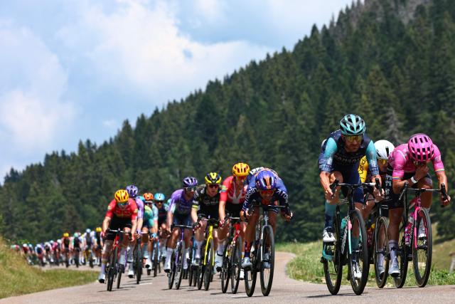 cycles with the pack of riders (peloton) cycles during the 15th stage of the 113th edition of the Tour de France cycling race, 183,9 km between Champagnole and Plateau de Solaison in the Jura mountains, on July 19, 2026. (Photo by Anne-Christine POUJOULAT / AFP)