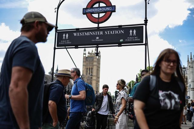 People walk past an entrance to the underground station at Westminster in central London on July 19, 2026, a day ahead of when Prime Minister Keir Starmer steps down and Andy Burnham becomes the next British leader. Little known on the international stage, Andy Burnham is expected to broadly maintain Keir Starmer's position on major foreign policy issues as the UK's next prime minister on July 20. (Photo by Henry NICHOLLS / AFP)