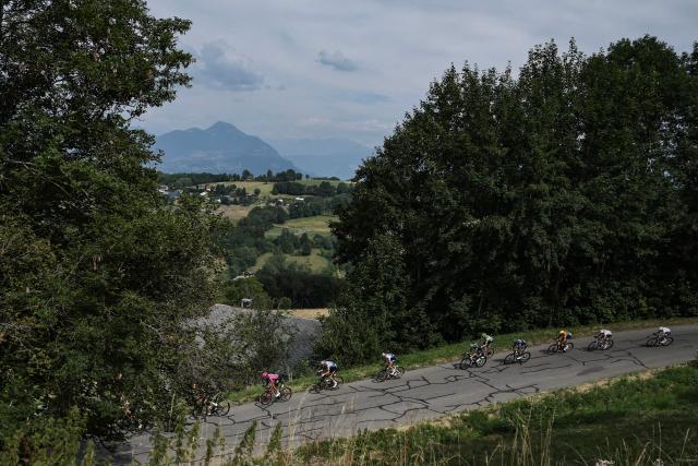 The pack of riders (peloton) cycles in a breakaway in the descent of the Col de la Croisette during the 15th stage of the 113th edition of the Tour de France cycling race, 183,9 km between Champagnole and Plateau de Solaison in the Jura mountains, on July 19, 2026. (Photo by Anne-Christine POUJOULAT / AFP)