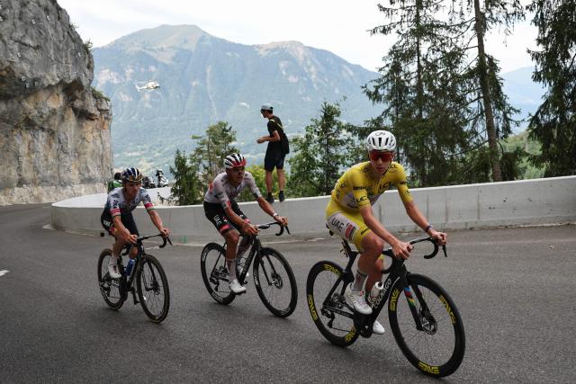 UAE Team Emirates - XRG's Slovenian rider Tadej Pogacar wearing the overall leader's yellow jersey, UAE Team Emirates - XRG's Mexican rider Isaac Del Toro and Red Bull - BORA - hansgrohe team's Belgian rider Remco Evenepoel cycle in the lead breakaway in the final ascent of the 15th stage of the 113th edition of the Tour de France cycling race, 183,9 km between Champagnole and Plateau de Solaison in the Jura mountains, on July 19, 2026. (Photo by Anne-Christine POUJOULAT / AFP)