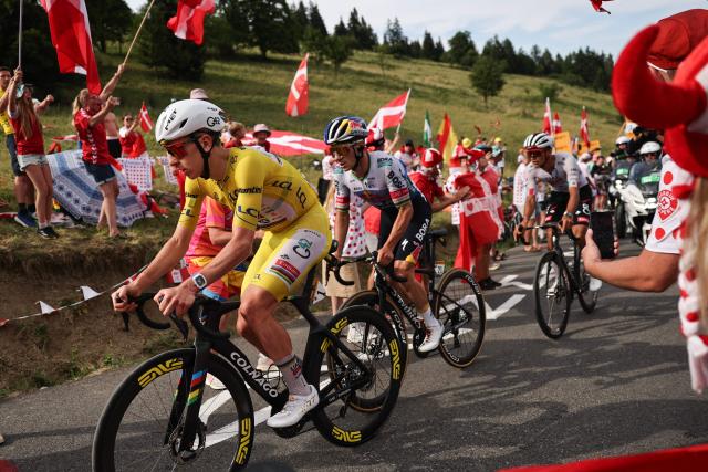 UAE Team Emirates - XRG's Slovenian rider Tadej Pogacar wearing the overall leader's yellow jersey, Red Bull - BORA - hansgrohe team's Belgian rider Remco Evenepoel and UAE Team Emirates - XRG's Mexican rider Isaac Del Toro cycle in the lead breakaway in the final ascent of the 15th stage of the 113th edition of the Tour de France cycling race, 183,9 km between Champagnole and Plateau de Solaison in the Jura mountains, on July 19, 2026. (Photo by Anne-Christine POUJOULAT / AFP)