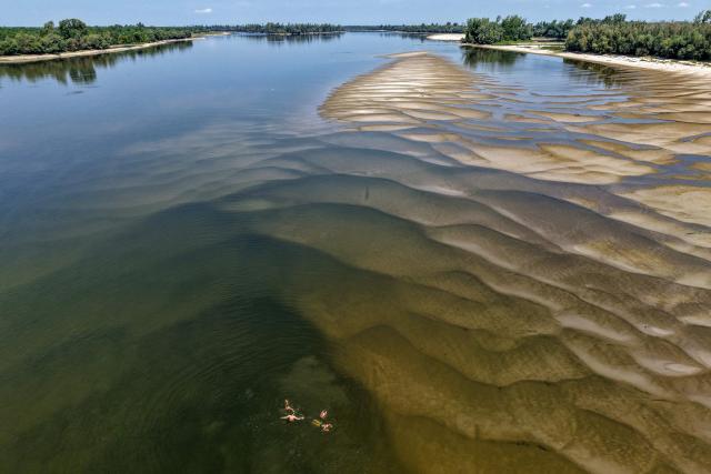 This aerial view shows the low water level of the Danube River near Backa Palanka, Serbia, on July 19, 2026. (Photo by Nenad MIHAJLOVIC / AFP)