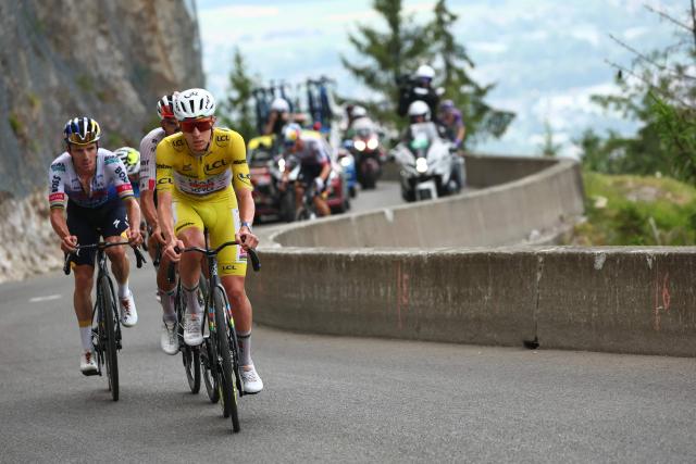 UAE Team Emirates - XRG's Slovenian rider Tadej Pogacar wearing the overall leader's yellow jersey and Red Bull - BORA - hansgrohe team's Belgian rider Remco Evenepoel cycles in the final ascent of the 15th stage of the 113th edition of the Tour de France cycling race, 183,9 km between Champagnole and Plateau de Solaison in the Jura mountains, on July 19, 2026. (Photo by Anne-Christine POUJOULAT / AFP)
