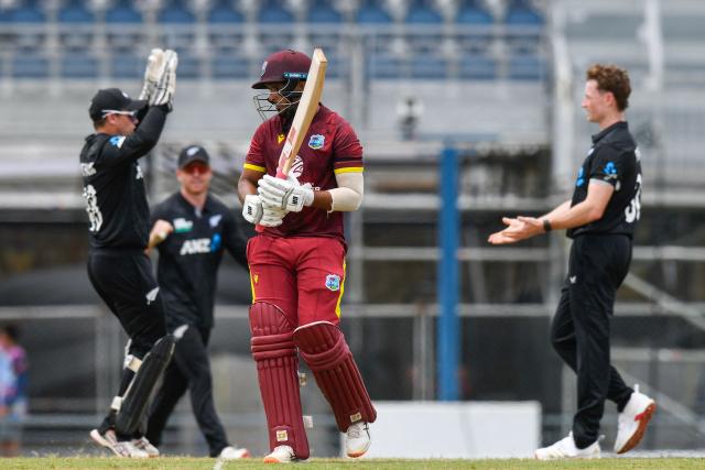 Amir Jangoo (C) of West Indies walks off the field after being dismissed by Matt Fisher (R) of New Zealand during the 4th One-Day International (ODI) cricket match between West Indies and New Zealand at Kensington Oval in Bridgetown, Barbados on July 19, 2026. (Photo by Randy Brooks / AFP)