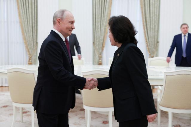 In this pool photograph distributed by the Russian state agency Sputnik, Russia's President Vladimir Putin shakes hands with North Korea's Foreign Minister Choe Son-hui during a meeting in Moscow on July 19, 2026. (Photo by Alexander SHCHERBAK / POOL / AFP)