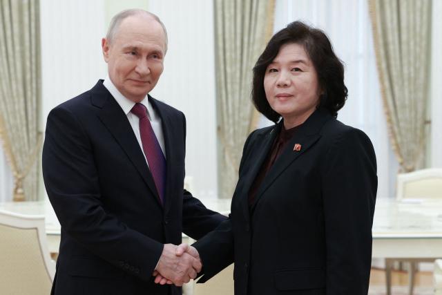 In this pool photograph distributed by the Russian state agency Sputnik, Russia's President Vladimir Putin shakes hands with North Korea's Foreign Minister Choe Son-hui during a meeting in Moscow on July 19, 2026. (Photo by Alexander SHCHERBAK / POOL / AFP)