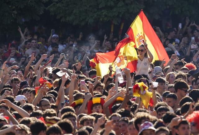 Spain's supporters cheer prior the 2026 World Cup final match between Spain and Argentina in front of giant screens at Colon square's fan zone in Madrid, on July 19, 2026. (Photo by Paul Hanna / AFP)