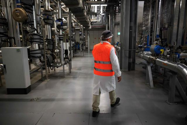 Eric Feunteun, CEO of Diam Bouchonage, which specializes in the production of cork stoppers for the wine industry, walks through the company's production plant in Ceret, southwestern France, July 17, 2026. (Photo by Lionel BONAVENTURE / AFP)