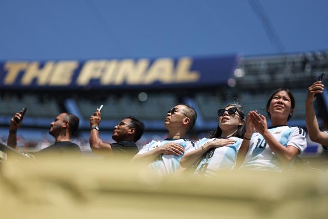 Argentina fans stand for the US national anthem ahead of the 2026 World Cup football tournament final match between Spain and Argentina at the New York/New Jersey Stadium in East Rutherford on July 19, 2026.  (Photo by PATRICIA DE MELO MOREIRA / AFP)