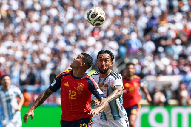 Spain's defender #12 Pedro Porro and Argentina's forward #15 Nicolas Gonzalez fight for the ball during the 2026 World Cup football tournament final match between Spain and Argentina at the New York/New Jersey Stadium in East Rutherford on July 19, 2026.  (Photo by FRANCK FIFE / AFP)