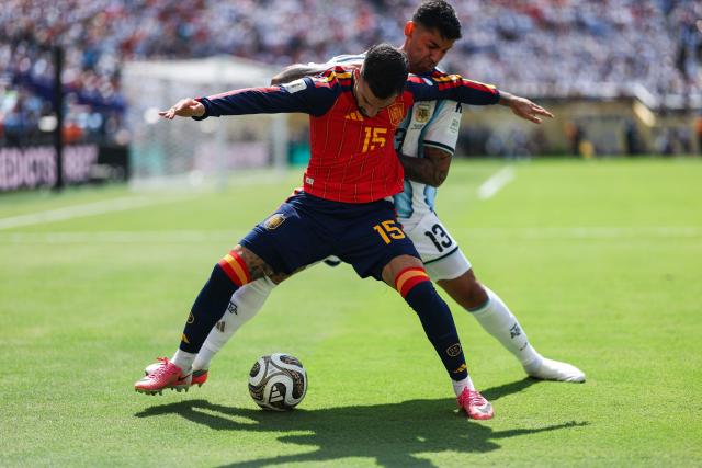 Spain's midfielder #15 Alex Baena and Argentina's defender #13 Cristian Romero fight for the ball during the 2026 World Cup football tournament final match between Spain and Argentina at the New York/New Jersey Stadium in East Rutherford on July 19, 2026.  (Photo by PATRICIA DE MELO MOREIRA / AFP)
