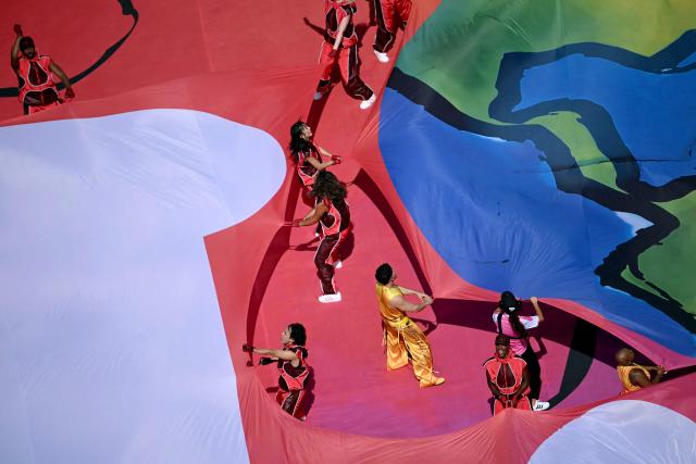 Performers hold banners at the Half Time Show during the 2026 World Cup football tournament final match between Spain and Argentina at the New York/New Jersey Stadium in East Rutherford on July 19, 2026.  (Photo by MAURO PIMENTEL / AFP)