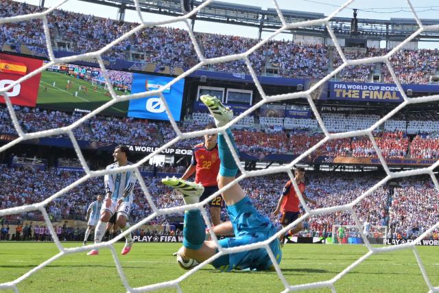 Spain's goalkeeper #23 Unai Simon dives to stop the ball during the 2026 World Cup football tournament final match between Spain and Argentina at the New York/New Jersey Stadium in East Rutherford on July 19, 2026.  (Photo by JUAN MABROMATA / AFP)