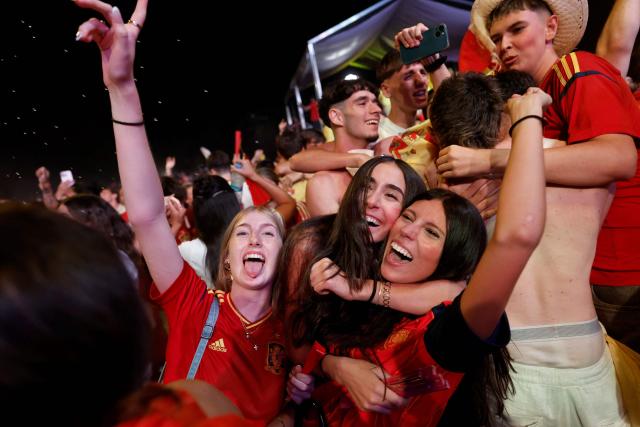 Spain's supporters celebrate Spain's first goal during the 2026 World Cup final match between Spain and Argentina displayed on giant screens at Colon square's fan zone in Madrid, on July 19, 2026. (Photo by Oscar DEL POZO / AFP)