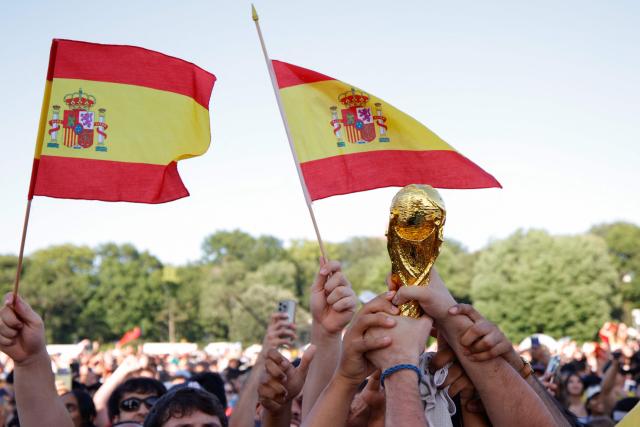 Spain fans hold up a replica trophy and flags as they celebrate their team's victory after watching the 2026 World Cup Final between Spain and Argentina at Central Park in New York on July 19, 2026. (Photo by Leonardo Munoz / AFP)