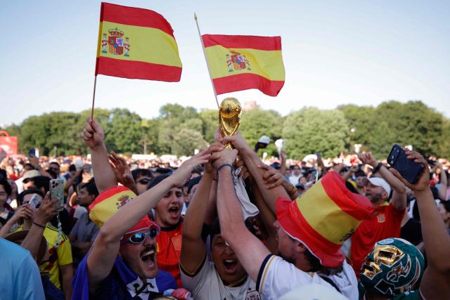 Spain fans cheer and hold up a replica trophy after their team won as they watch the 2026 World Cup Final between Spain and Argentina at Central Park in New York on July 19, 2026. (Photo by Leonardo Munoz / AFP)