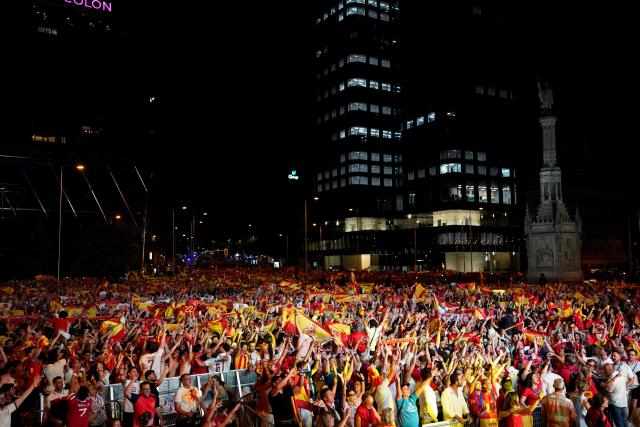 Spain's supporters celebrate victory after the 2026 World Cup final match between Spain and Argentina displayed on giant screens at Colon square's fan zone in Madrid, on July 19, 2026. (Photo by Paul Hanna / AFP)
