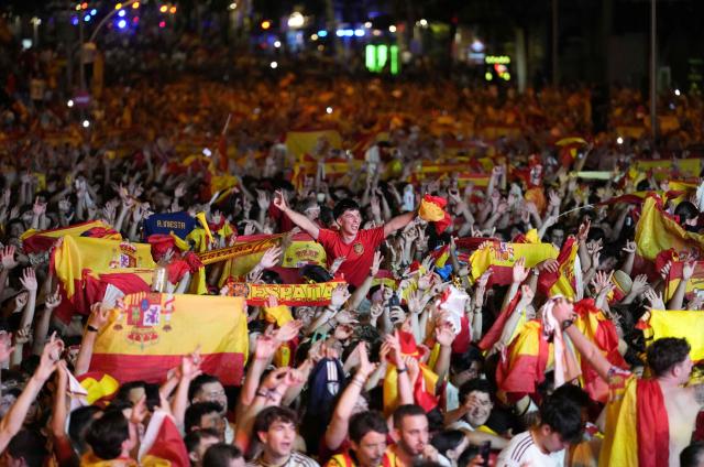 Spain's supporters celebrate victory after the 2026 World Cup final match between Spain and Argentina displayed on giant screens at Colon square's fan zone in Madrid, on July 19, 2026. (Photo by Paul Hanna / AFP)
