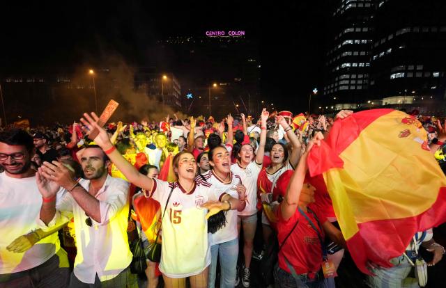 Spain's supporters celebrate victory after the 2026 World Cup final match between Spain and Argentina displayed on giant screens at Colon square's fan zone in Madrid, on July 19, 2026. (Photo by Paul Hanna / AFP)