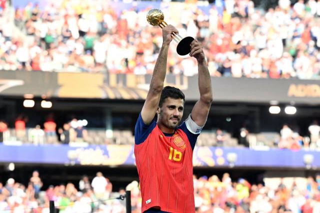 Spain's midfielder #16 Rodri lifts his most valuable player trophy at the end of the 2026 World Cup football tournament final match between Spain and Argentina at the New York/New Jersey Stadium in East Rutherford on July 19, 2026.  (Photo by Mandel NGAN / AFP)