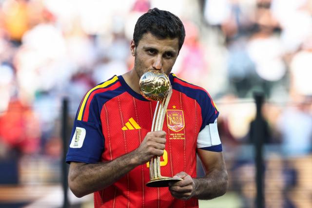 Spain's midfielder #16 Rodri kisses the Golden Ball Award during the award ceremony of the 2026 World Cup football tournament final match between Spain and Argentina at the New York/New Jersey Stadium in East Rutherford on July 19, 2026.  (Photo by FRANCK FIFE / AFP)
