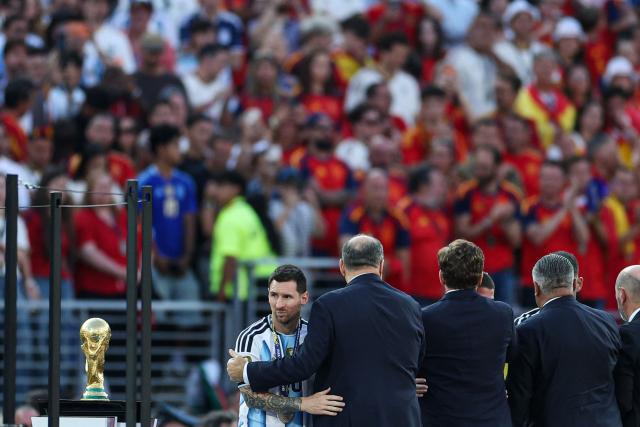 Argentina's forward #10 Lionel Messi looks on next to the trophy after losing the 2026 World Cup football tournament final match between Spain and Argentina at the New York/New Jersey Stadium in East Rutherford on July 19, 2026.  (Photo by PATRICIA DE MELO MOREIRA / AFP)