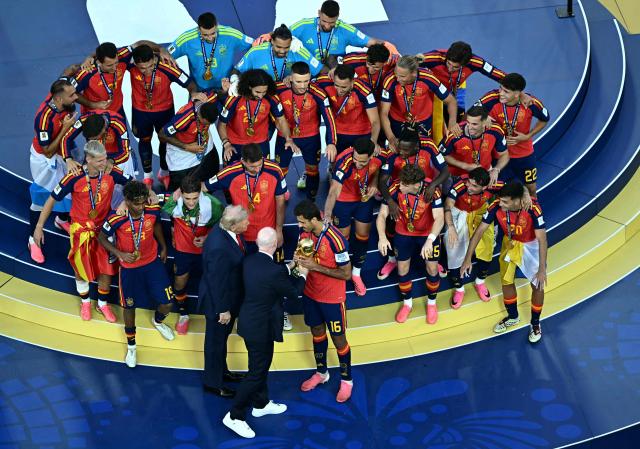 US President Donald Trump and FIFA President Gianni Infantino hand the trophy to Spain's midfielder #16 Rodri during the trophy ceremony after Spain won the 2026 World Cup football tournament final match between Spain and Argentina at the New York/New Jersey Stadium in East Rutherford on July 19, 2026.  (Photo by Jewel SAMAD / AFP)