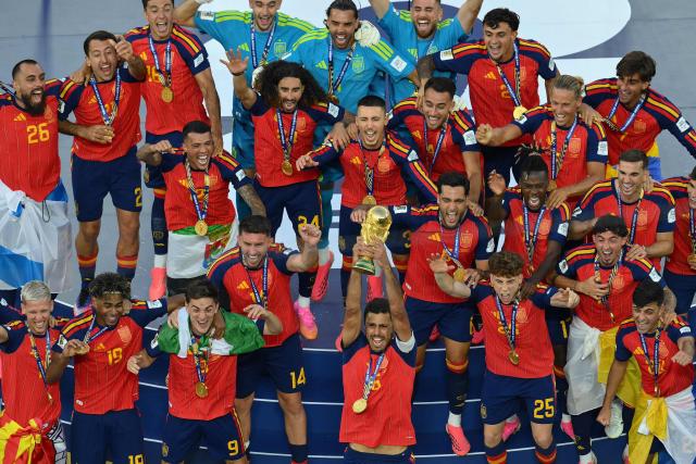 Spain's midfielder #16 Rodri (front C) lifts the trophy as he celebrates with Spain's players during the final ceremony after the 2026 World Cup football tournament final match between Spain and Argentina at the New York/New Jersey Stadium in East Rutherford on July 19, 2026.  (Photo by ANGELA WEISS / AFP)