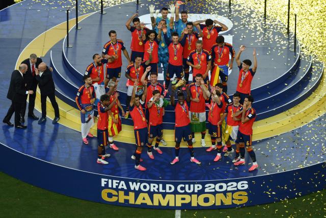 Spain's forward #17 Nico Williams (front C) lifts the FIFA World Cup Trophy as he celebrates with Spain's players during the final ceremony after the 2026 World Cup football tournament final match between Spain and Argentina at the New York/New Jersey Stadium in East Rutherford on July 19, 2026.  (Photo by ANGELA WEISS / AFP)