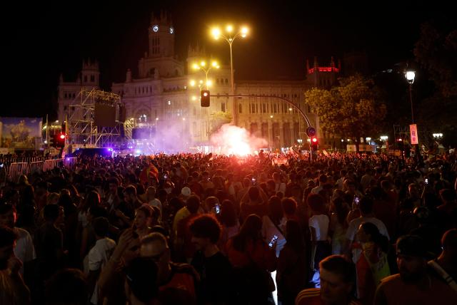 Spain's supporters celebrate after winning the 2026 World Cup final match between Spain and Argentina, at Cibeles square in Madrid on July 19, 2026. (Photo by Oscar DEL POZO / AFP)