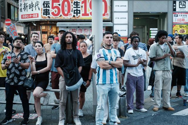 People watch a live broadcast of the 2026 World Cup football final match between Spain and Argentina on a street in the early morning in Shibuya, Tokyo, on July 20, 2026. (Photo by Yasuyoshi CHIBA / AFP)