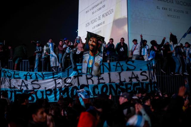Argentina's fans hold a banner featuring an image of Lionel Messi as they gather at the Obelisk after Argentina lost the FIFA World Cup final football match against Spain in Buenos Aires on July 19, 2026. Spain won by 1-0. (Photo by TOMAS CUESTA / AFP)