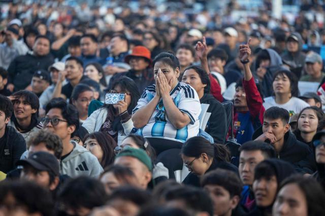An Argentina fan (C) reacts while watching a live broadcast of the 2026 World Cup football final match between Spain and Argentina at a watch party in a stadium in Ulaanbaatar, the capital of Mongolia, early on July 20, 2026. (Photo by BYAMBASUREN BYAMBA-OCHIR / AFP)