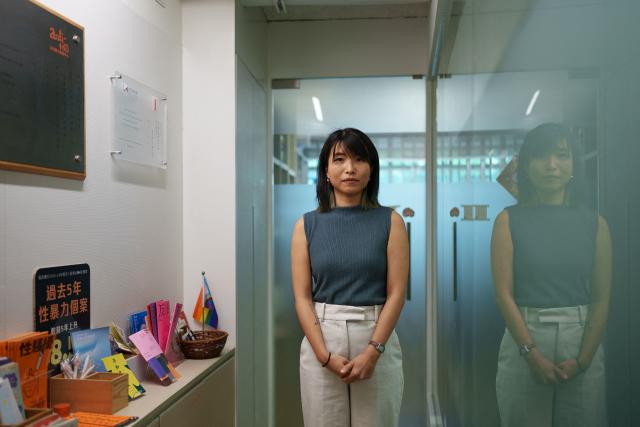 Cheryl Yip, an advocacy officer for the Association Concerning Sexual Violence Against Women (ACSVAW), poses for a photo at the NGOs office in Hong Kong on June 22, 2026. Hong Kong has sought to overhaul its decades-old sexual offence laws, opening sweeping reforms to public consultation this month. The long-awaited reforms will introduce stricter penalties for sexual crimes, but survivors say the changes still do not bar the defence of "mistaken belief". (Photo by Yan ZHAO / AFP) / To go with AFP story Hong Kong-China-crime-law-women-children, FOCUS by Tommy WANG
