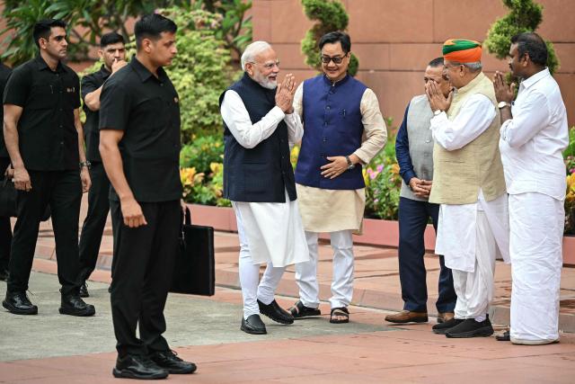 India's Prime Minister Narendra Modi (C) greets his fellow lawmakers upon his arrival on the first day of the monsoon session of the parliament in New Delhi on July 20, 2026. (Photo by Sajjad HUSSAIN / AFP)