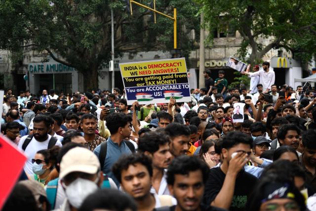 Activists and supporters of the Cockroach Janta Party (CJP) take part in a protest demanding the resignation of India's Education Minister Dharmendra Pradhan over alleged NEET examination irregularities in New Delhi on July 20, 2026. (Photo by Manan VATSYAYANA / AFP)
