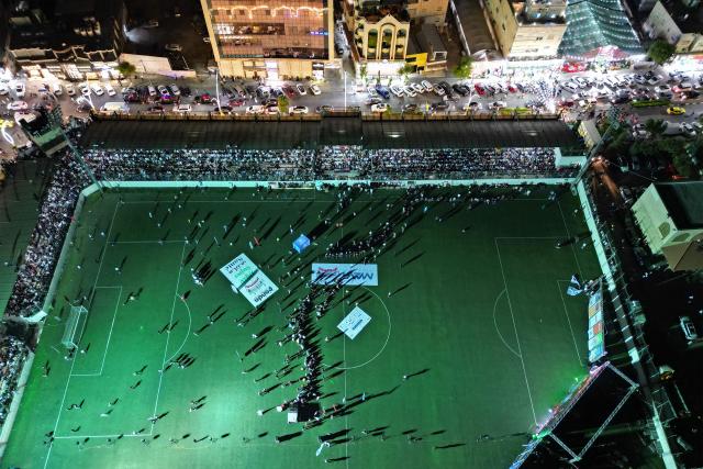 This aerial photo shows Palestinian fans watching the live broadcast of the 2026 World Cup final football match between Argentina and Spain, at the Al-Hussein Stadium in Hebron on July 19, 2026. (Photo by HAZEM BADER / AFP)