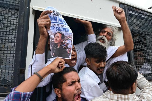Supporters of the Cockroach Janta Party (CJP) shout slogans as police detain them during a protest demanding the resignation of India's Education Minister Dharmendra Pradhan over alleged NEET examination irregularities in Ahmedabad on July 20, 2026. (Photo by Shammi MEHRA / AFP)