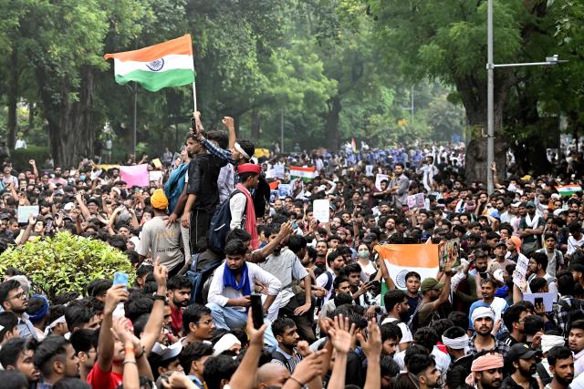 Activists and supporters of the Cockroach Janta Party (CJP) take part in a protest demanding the resignation of India's Education Minister Dharmendra Pradhan over alleged NEET examination irregularities in New Delhi on July 20, 2026. (Photo by Arun SANKAR / AFP)