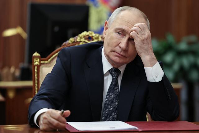 In this pool photograph distributed by the Russian state agency Sputnik, Russia's President Vladimir Putin meets with Moscow-installed leader of the Russian-controlled parts of the Zaporizhzhia region, at the Kremlin in Moscow on July 20, 2026. (Photo by Alexander KAZAKOV / POOL / AFP)