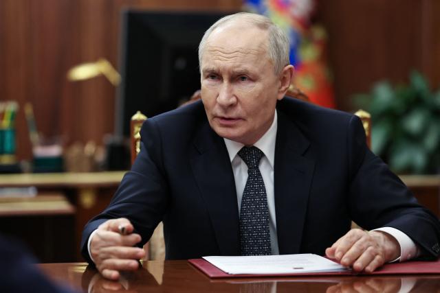 In this pool photograph distributed by the Russian state agency Sputnik, Russia's President Vladimir Putin meets with Moscow-installed leader of the Russian-controlled parts of the Zaporizhzhia region, at the Kremlin in Moscow on July 20, 2026. (Photo by Alexander KAZAKOV / POOL / AFP)