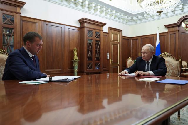 In this pool photograph distributed by the Russian state agency Sputnik, Russia's President Vladimir Putin (R) meets with Yevgeny Balitsky, Moscow-installed leader of the Russian-controlled parts of the Zaporizhzhia region, at the Kremlin in Moscow on July 20, 2026. (Photo by Alexander KAZAKOV / POOL / AFP)
